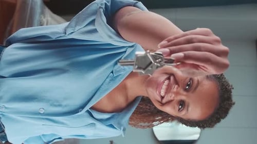 Smiling Woman Holds Keys to New Home