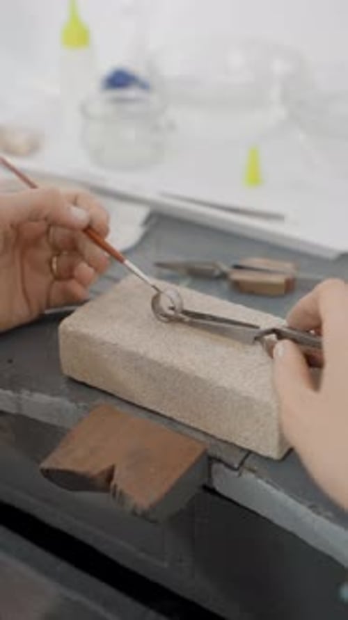 Hands Of Female Jeweler Creating Jewelry In Her Workshop Close Up