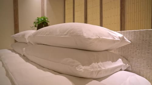 white pillows decoration on bed in luxury hotel resort bedroom