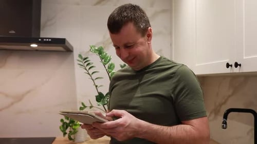Man Using Tablet in Modern Kitchen