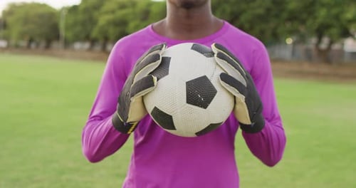 Video of african american football player on field with ball