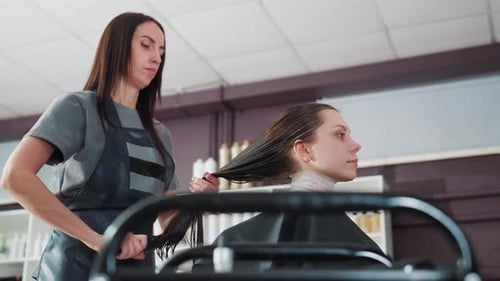 Woman getting her hair styled at salon