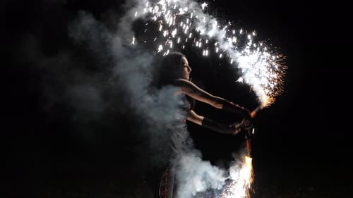 The Artist of the Fire Show in Black Clothes Throws Fire Sparks