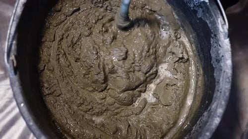 Mortar Being Mixed in a Black Bucket