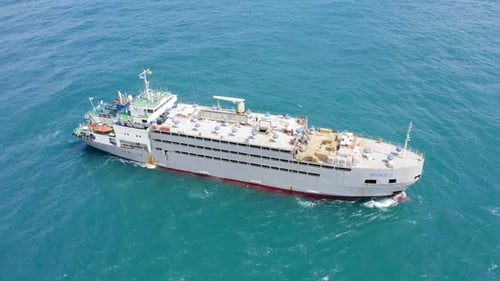 Aerial footage of a Medium size Livestock carrier cruising slowly
