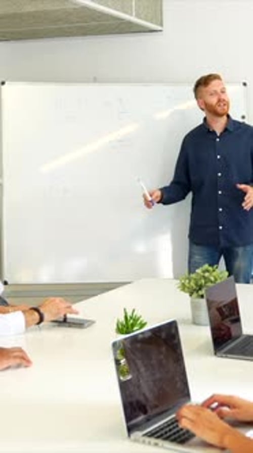 Young Adult Leads Meeting in Bright Office