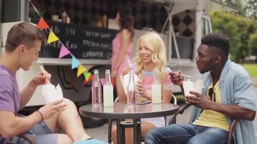 Friends Eating Food from a Food Truck