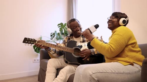 Senior Couple Singing and Playing Guitar Together
