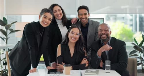 Smiling Business Associates Posing Together at Desk