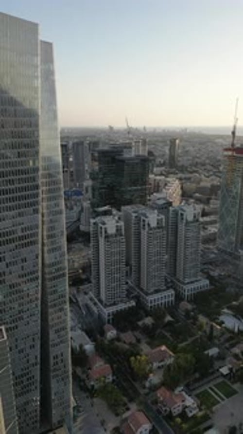 Aerial Shot Of Cityscape By Sea Against Sky At Sunset, Drone Descending Forward Over City - Tel Aviv