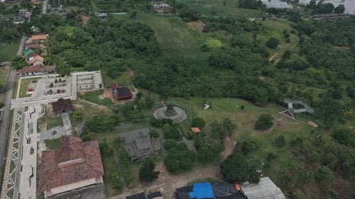 Aerial View Of A Serene Landscape With Lush Greenery And Buildings