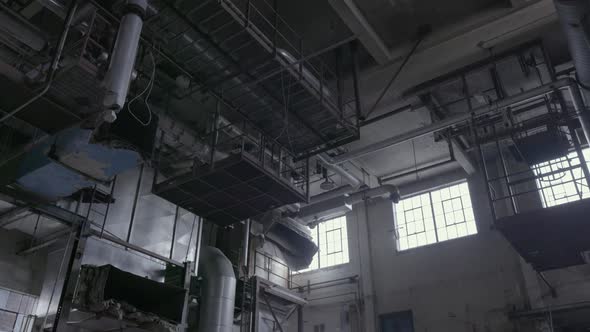 A tilt shot starting at the ceiling with the metal catwalk down to the ...