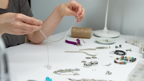 Handcrafting Delicate Jewelry at a White Table