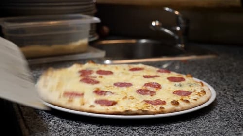 Delicious Pizza Being Placed On A White Plate