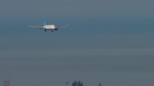 Passenger Plane Flies Over Town Approaching Landing