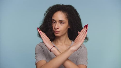Woman Making an X Sign with Arms in Refusal