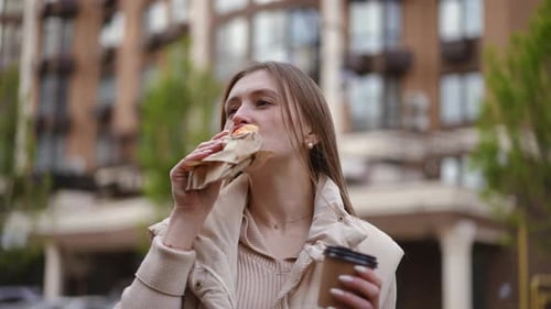 Woman Eating Pastry and Drinking Coffee Outdoors