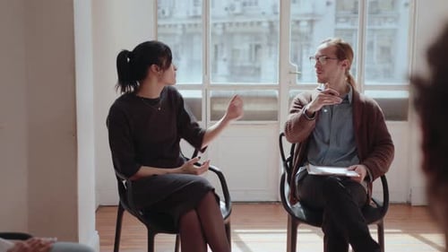 Professional Therapist Working with Group of People at Community Center