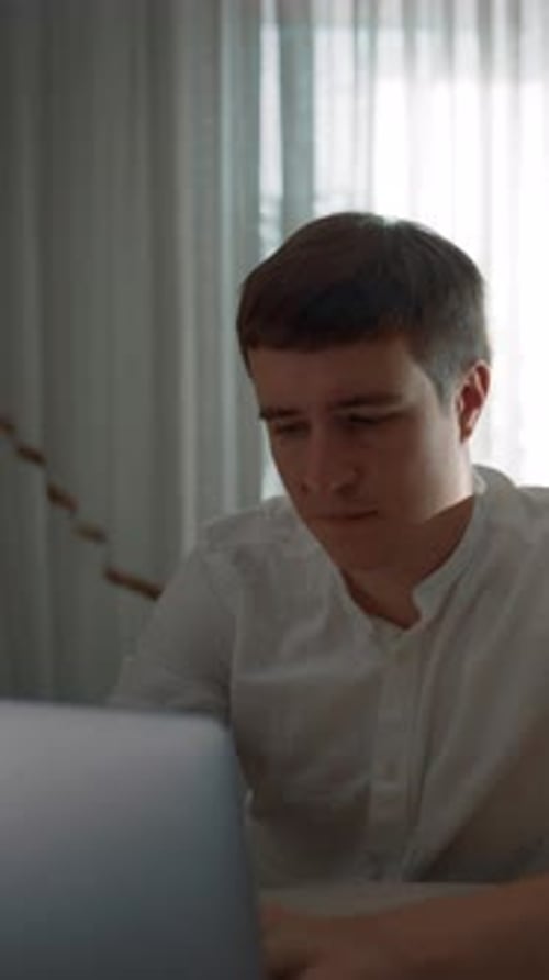 Young Man Using Laptop Computer Indoors