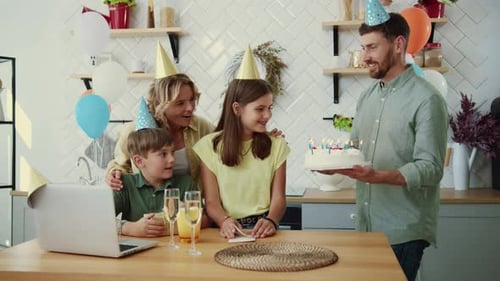 Family Celebrates Birthday Together in Kitchen