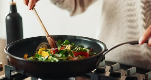 Hands, spoon and cooking in house for brunch, eating and health with nutrition, flavor and stir fry