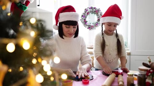 Woman and Child Baking Cookies at Christmas