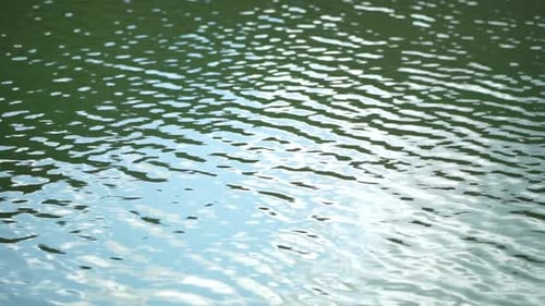 Sun Reflecting on Sparkling Sea Lake Water Surface Ocean at Sunset Sunrise Sunrays Flickering in