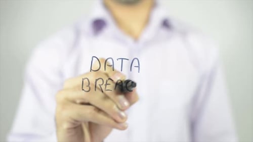 Data Breach Written on Glass by Adult