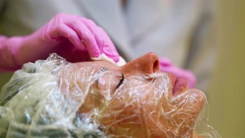 Woman Receiving Facial at Beauty Clinic Close Up