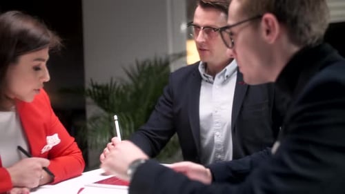 In Creative Office Productive Coworkers Standing at the Table Company Meeting Business People