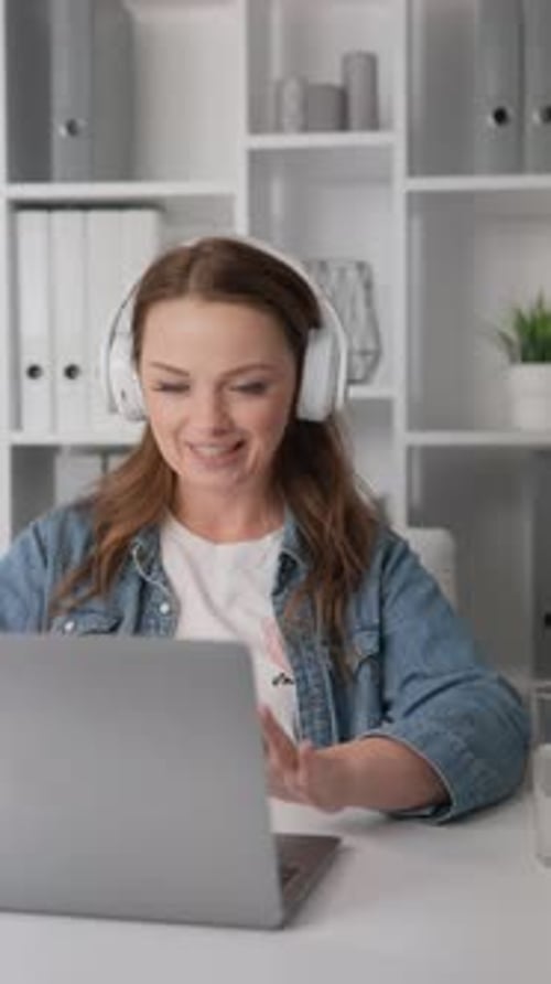 Woman Uses Laptop for Online Video Meeting