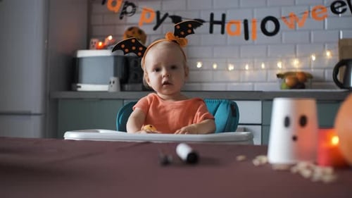 Adorable Infant Celebrates Halloween in Festive Kitchen Setting
