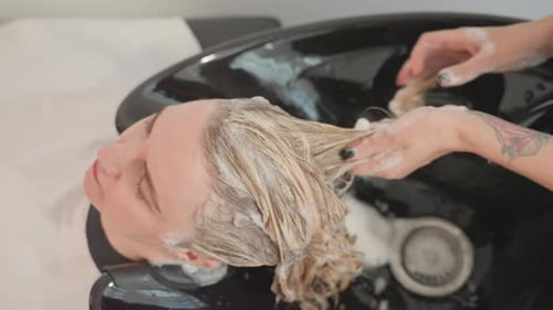 Woman Getting Shampooed at Hair Salon