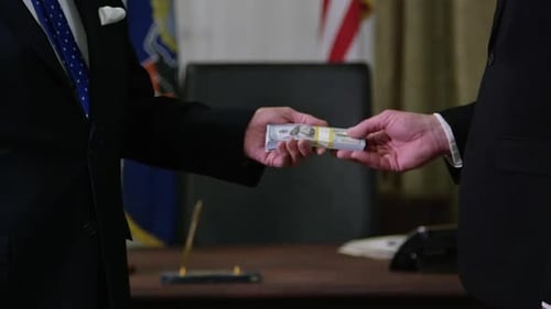 Money in Politics - handshake and cash exchange HD