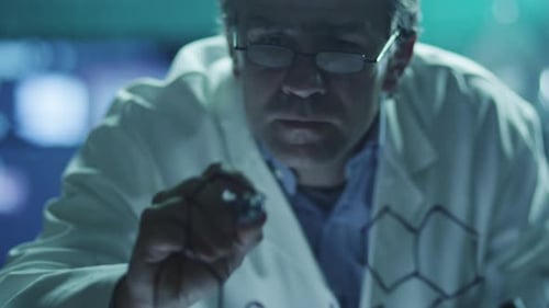 Scientist is Drawing Organic Chemical Formulas on Glass