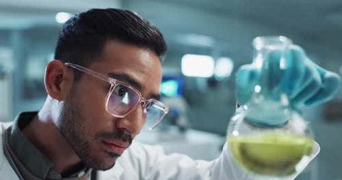 Serious man, scientist and beaker with chemical for research, experiment or test in lab