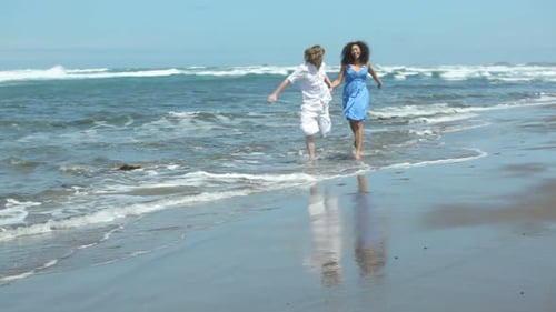 Couple Holding Hands and Running on Beach Together 20-25