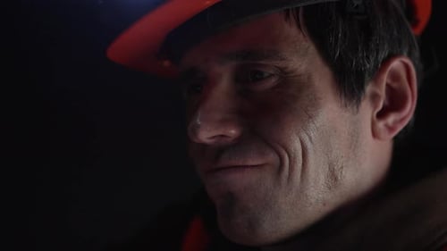 Close Up of Person Wearing Hard Hat and Vest