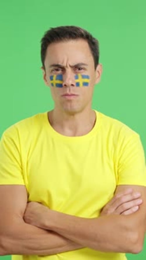Dignified and Serious Man with Swedish Flag Painted on Face