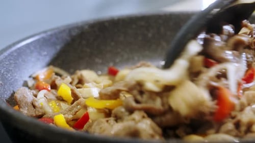 Meat and Vegetables Cooking in a Pan
