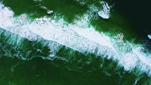 Aerial descending from 400 feet over ocean wave patterns and textures