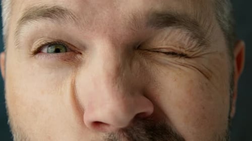 Funny Male with Smiling Green Eyes Winking Making Silly Faces Grimacing Closeup