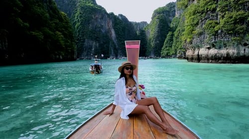 Women in Front of Longtail Boat at the Lagoon of Koh Phi Phi Thailand