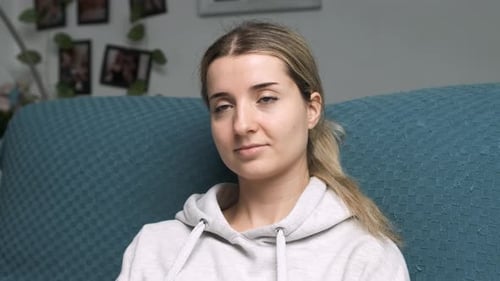 Woman Relaxing on Couch Changing Tv Channel