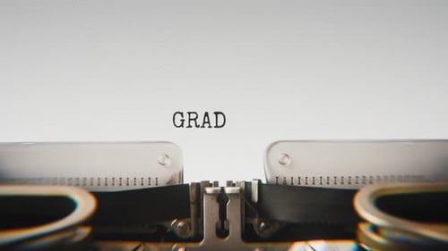 Old mechanical typewriter typing Graduation in a close-up view.