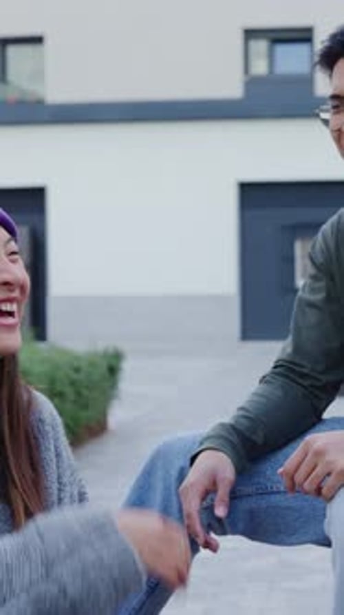 Happy Young Diverse Ethnic Friends Chatting and Having Fun Outdoors
