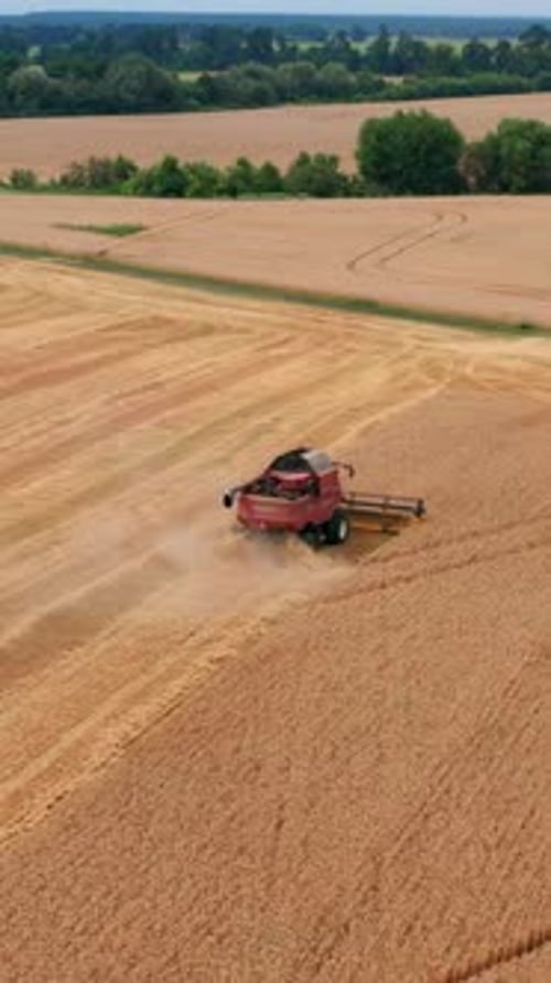 Industrial machinery gathering. Aerial view countryside farmland. Vertical video