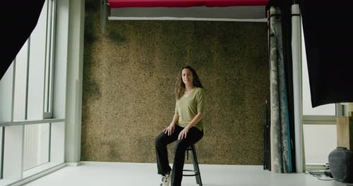 Portrait of an Hispanic Woman sitting in a Photographic studio