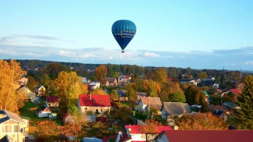 Scenic View Of Hot Air Balloon Flying Over Vilnius Town During Autumn Season. Aerial Tracking Shot