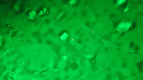 Green Colored Water Surface Moving Waves with Oil Bubbles Under Ultra Sound Vibrations Abstract